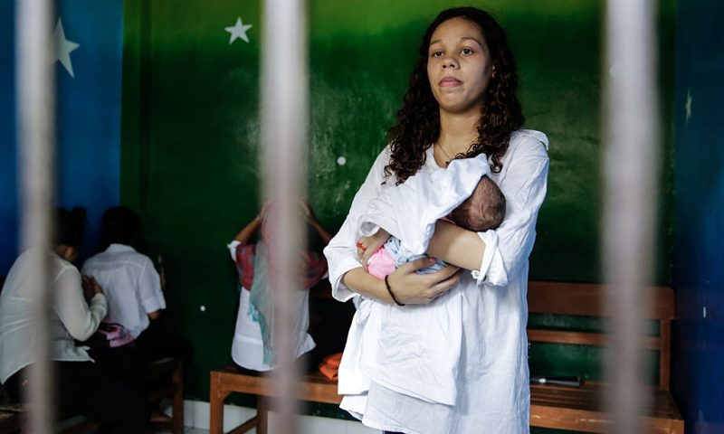 Heather Mack, 19, of the US holds her baby in a cell before her sentence demand trial on March 31, 2015 in Denpasar, Bali, Indonesia. Indonesian prosecutors asked a court to sentence Heather Mack to 15 years and Tommy Schaefer to 18 years in jail. Tommy Schaefer and his girlfriend Heather Mack are accused of murdering Mack's mother, Sheila von Wiese-Mack, whose body was found stuffed inside a suitcase in the back of a taxi outside a luxury Bali hotel in August 2014. (Photo by Agung Parameswara/Getty Images)