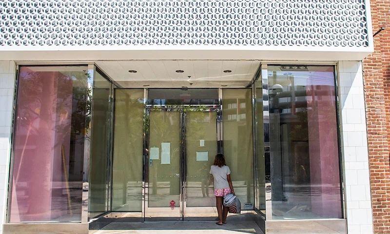A woman looks through the window of a closed commercial business at the Promenade in Santa Monica, California, on September 13, 2022. - US annual inflation slowed slightly in August, largely thanks to falling gasoline prices -- but likely not enough to satisfy the Federal Reserve and President Joe Biden, as high prices continue inflicting pain on Americans. (Photo by Apu GOMES / AFP) (Photo by APU GOMES/AFP via Getty Images)
