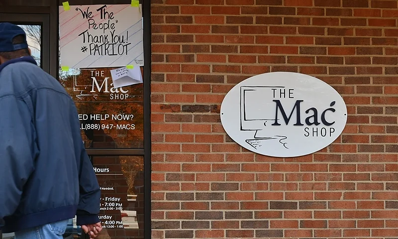 A man walks past "The Mac Shop" in Wilmington, Delaware on October 21, 2020. - The New York Post last week revived allegations against Hunter Biden with a story claiming it had obtained documents from a laptop owned by the former vice president's son which was brought in for repairs to the shop in April 2019 but never picked up. The Post claimed that emails found on the laptop showed that Hunter Biden introduced his father to a Burisma advisor, Vadym Pozharskyi, in 2015 and contradict Joe Biden's claims that he never spoke to his son about his overseas business dealings. The Post said the shop owner handed the laptop over to the FBI and also made a copy of the hard drive and gave it to former New York mayor Rudy Giuliani. (Photo by Angela Weiss / AFP) (Photo by ANGELA WEISS/AFP via Getty Images)