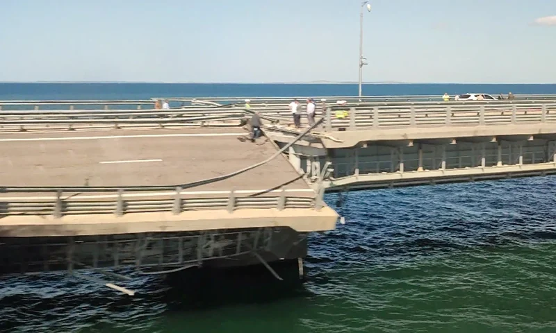 A view through a train window shows the section of a road split and sloping to one side following an alleged attack on the Crimea Bridge, that connects the Russian mainland with the Crimean peninsula across the Kerch Strait, in this still image from video taken July 17, 2023. REUTERS/Stringer