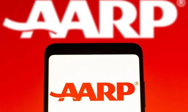 In this photo illustration, the American Association of Retired Persons (AARP) logo seen displayed on a smartphone screen and in the background. (Photo Illustration by Rafael Henrique/SOPA Images/LightRocket via Getty Images)