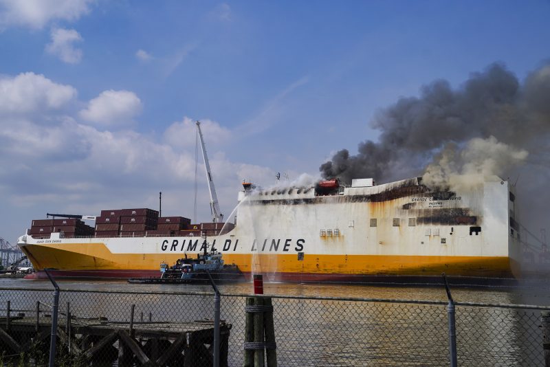 Emergency personnel battle against a fire aboard the Italian-flagged Grande Costa d'Avorio cargo ship at the Port of Newark, Friday, July 7, 2023, in Newark, N.J. The cargo ship burned for a third day Friday at the port after a fire that claimed the lives of two Newark firefighters Augusto "Augie" Acabou and Wayne "Bear" Brooks Jr. , and exposed gaps in the ability of fire crews to respond to emergencies on hulking container ships. (AP Photo/John Minchillo)