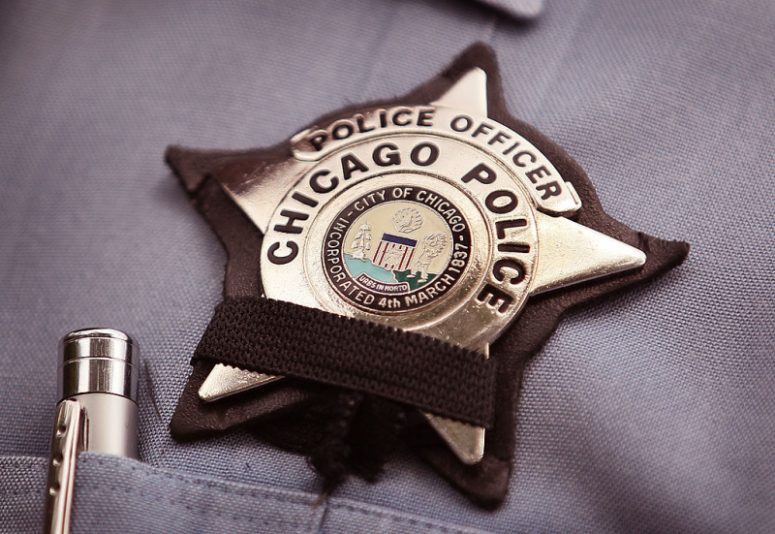 CHICAGO - JULY 19: A black band is stretched across a District 1 Chicago Police officer's badge to mourn the death of a fellow officer on July 19, 2010 in Chicago, Illinois. District 1 officer Michael Bailey was killed in front of his home after getting off duty Sunday morning in what appeared to be an attempted carjacking. Bailey was the third Chicago police officer shot and killed since mid-May. (Photo by Scott Olson/Getty Images)