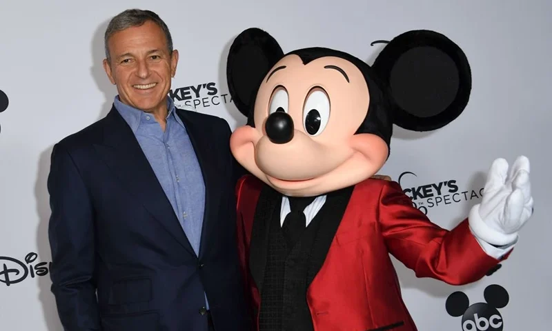 Walt Disney Company Chairman and CEO Robert A Iger poses with Mickey Mouse attends Mickey's 90th Spectacular at The Shrine Auditorium on October 6, 2018 in Los Angeles. (Photo by VALERIE MACON / AFP) (Photo credit should read VALERIE MACON/AFP via Getty Images)