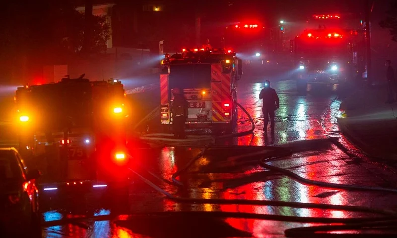 Firefighters work to save homes from the Saddleridge Fire in the Porter Ranch section of Los Angeles, California, on October 11, 2019. - The fire broke out late October 10 and has scorched some 4,600 acres (1,816 hectares), and forced mandatory evacuation orders for 12,700 homes. (Photo by DAVID MCNEW / AFP) (Photo by DAVID MCNEW/AFP via Getty Images)