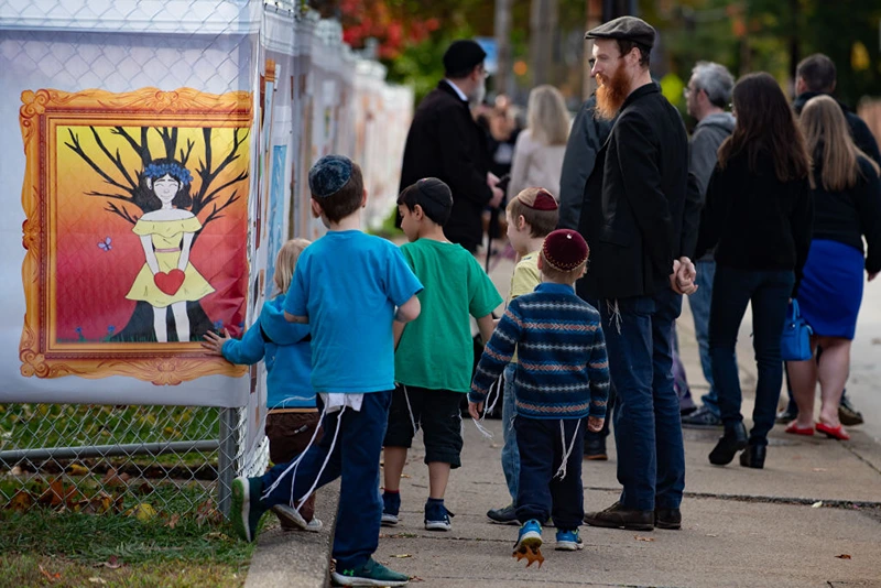 PITTSBURGH, PA - OCTOBER 27: Visitors look at inspired artworks along the fence at the Tree of Life Synagogue on the 1st Anniversary of the attack on October 27, 2019 in Pittsburgh, Pennsylvania. One year ago, Robert Bowers killed 11 people and wounded severa others during an attack of the Tree of Life synagogue. (Photo by Jeff Swensen/Getty Images)