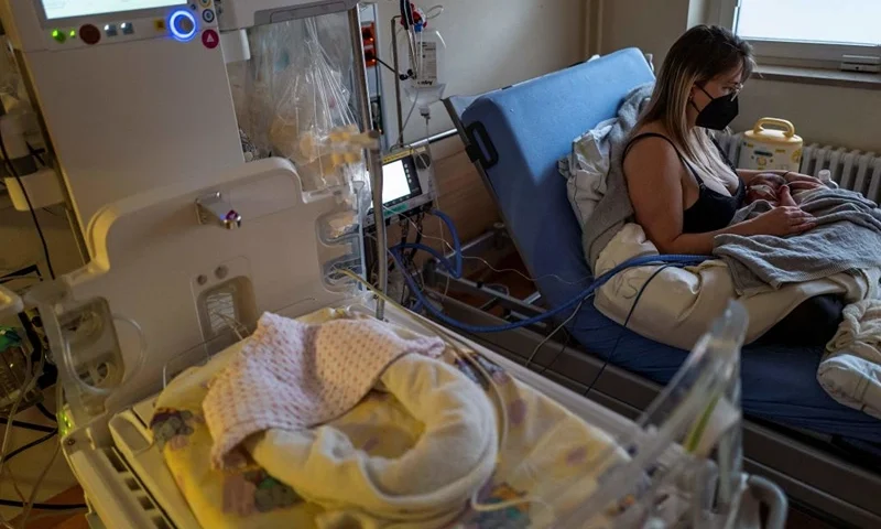 12-day-old Andreas wears a respirator as he lies with his mother in an intensive care unit at the pediatric ward of Berlin's Saint Joseph hospital on December 13, 2022. - Corona, flu, RSV - three infections are currently plaguing hospitals. (Photo by John MACDOUGALL / AFP) (Photo by JOHN MACDOUGALL/AFP via Getty Images)