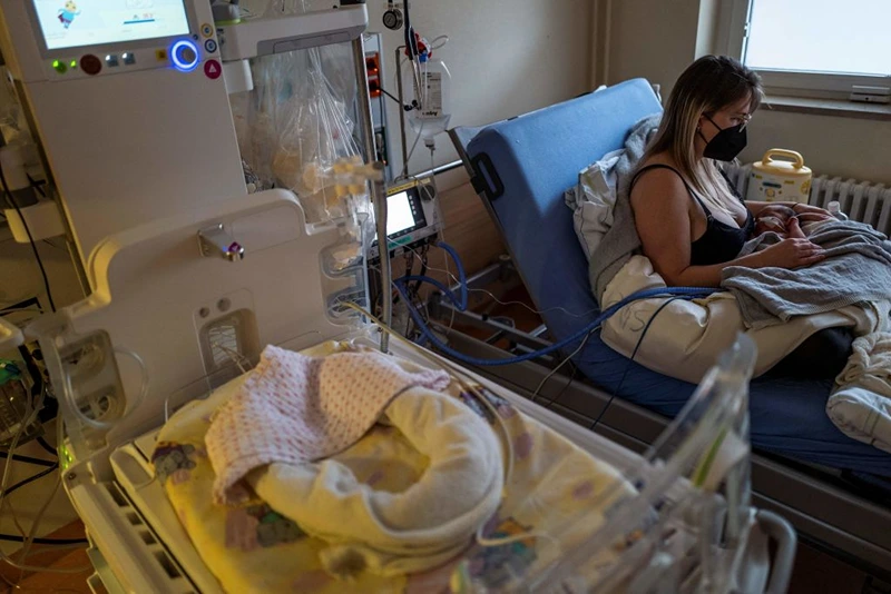 12-day-old Andreas wears a respirator as he lies with his mother in an intensive care unit at the pediatric ward of Berlin's Saint Joseph hospital on December 13, 2022. - Corona, flu, RSV - three infections are currently plaguing hospitals. (Photo by John MACDOUGALL / AFP) (Photo by JOHN MACDOUGALL/AFP via Getty Images)