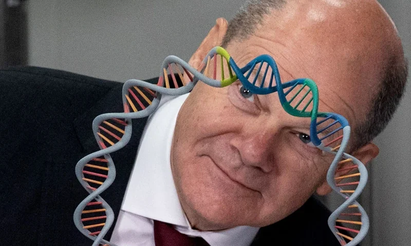 German Chancellor Olaf Scholz looks through the model of a plasmid DNA presented by the CEO of BioNtech Ugur Sahin during a visit at the German biopharmaceutical company plant BioNTech making mRNA-based vaccines and therapies in Marburg, central Germany, on February 2, 2023. (Photo by ANDRE PAIN / AFP) (Photo by ANDRE PAIN/AFP via Getty Images)
