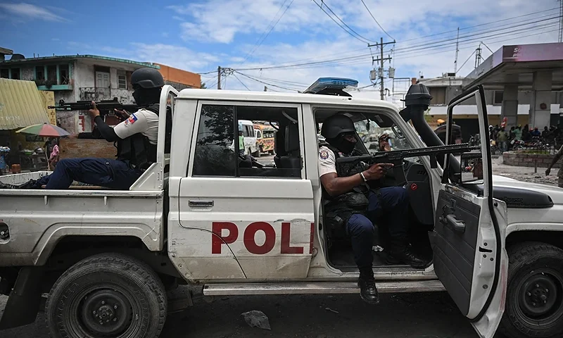TOPSHOT - Police officers patrol a neighborhood amid gang-related violence in downtown Port-au-Prince on April 25, 2023. - Between April 14 and 19, clashes between rival gangs left nearly 70 people dead, including 18 women and at least two children, according to a United Nations statement released April 24. (Photo by Richard PIERRIN / AFP) (Photo by RICHARD PIERRIN/AFP via Getty Images)