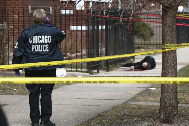 CHICAGO, IL - APRIL 01: (EDITORS NOTE: Image contains graphic content.) Chicago police investigate the murder of a 24-year-old man who was shot and killed on South Eberhart Avenue on the city's South Side April 1, 2013 in Chicago, Illinois. According to published reports, the man was the 73rd homicide victim and the 39th victim under the age of 25 in Chicago in 2013. (Photo by Scott Olson/Getty Images)