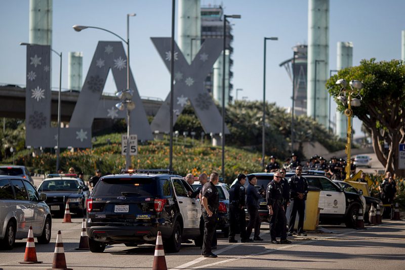 LOS ANGELES, CA - NOVEMBER 29: Police officers stand watch as fast-food, airport, home care and other workers protest to call for a higher minimum wage at Los Angeles International Airport (LAX) during nationwide 'Fight for $15 Day of Disruption' protests on November 29, 2016 in Los Angeles, California. Protest rallies are expected in nearly 20 airports and outside restaurants in numerous cities, according to organizers. In Los Angeles, fast-food workers a McDonald's restaurant walked off the jobs early this morning to demand a $15 per hour wage and union rights. 40 were arrested. (Photo by David McNew/Getty Images)