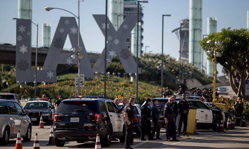 LOS ANGELES, CA - NOVEMBER 29: Police officers stand watch as fast-food, airport, home care and other workers protest to call for a higher minimum wage at Los Angeles International Airport (LAX) during nationwide 'Fight for $15 Day of Disruption' protests on November 29, 2016 in Los Angeles, California. Protest rallies are expected in nearly 20 airports and outside restaurants in numerous cities, according to organizers. In Los Angeles, fast-food workers a McDonald's restaurant walked off the jobs early this morning to demand a $15 per hour wage and union rights. 40 were arrested. (Photo by David McNew/Getty Images)
