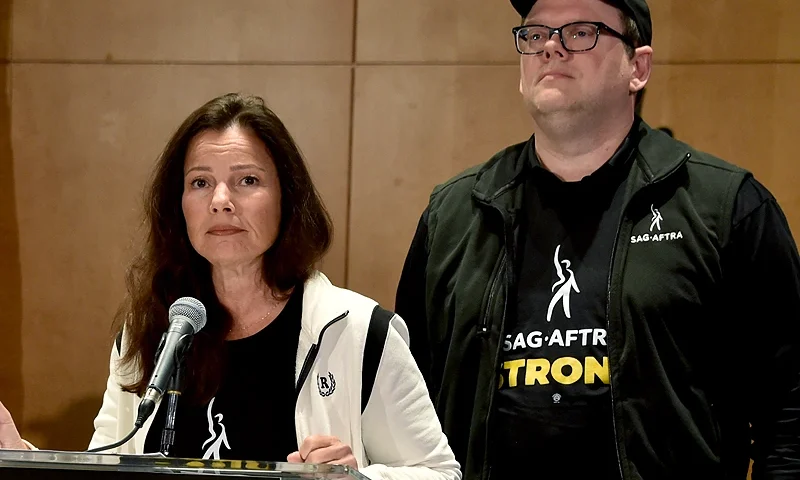 National Executive Director and Chief Negotiator Duncan Crabtree-Ireland looks on as SAG-AFTRA President US actress Fran Drescher (L) speaks during a press conference at the labor union's headquarters in Los Angeles, California, on July 13, 2023. Hollywood's actors' union on Thursday announced a strike against movie and television studios after talks over pay and other working conditions collapsed. The Screen Actors Guild (SAG-AFTRA), which represents some 160,000 performers, will walk out from midnight Thursday (0700 GMT Friday), said chief negotiator Duncan Crabtree-Ireland. (Photo by Chris Delmas / AFP) (Photo by CHRIS DELMAS/AFP via Getty Images)