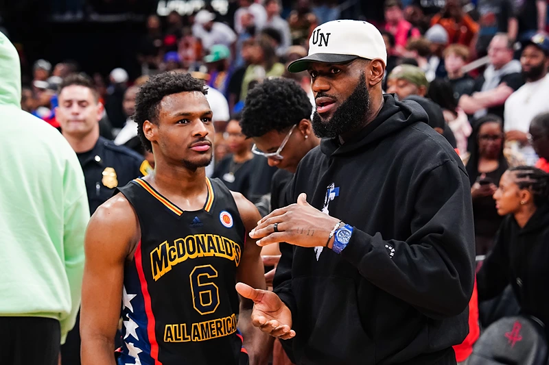HOUSTON, TEXAS - MARCH 28: Bronny James #6 of the West team talks to Lebron James of the Los Angeles Lakers after the 2023 McDonald's High School Boys All-American Game at Toyota Center on March 28, 2023 in Houston, Texas. (Photo by Alex Bierens de Haan/Getty Images)
