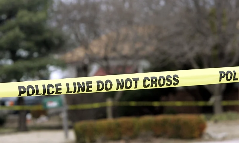 PARK CITY, KS - FEBRUARY 26: Police tape hangs across the street in front of the house that Dennis Rader lives in February 26, 2005 in Park City, Kansas. Rader is the suspect whom police have arrested on suspicion of first-degree murder in connection with the 10 deaths now tied to the serial killer known as BTK. (Photo by Larry W. Smith/Getty Images)