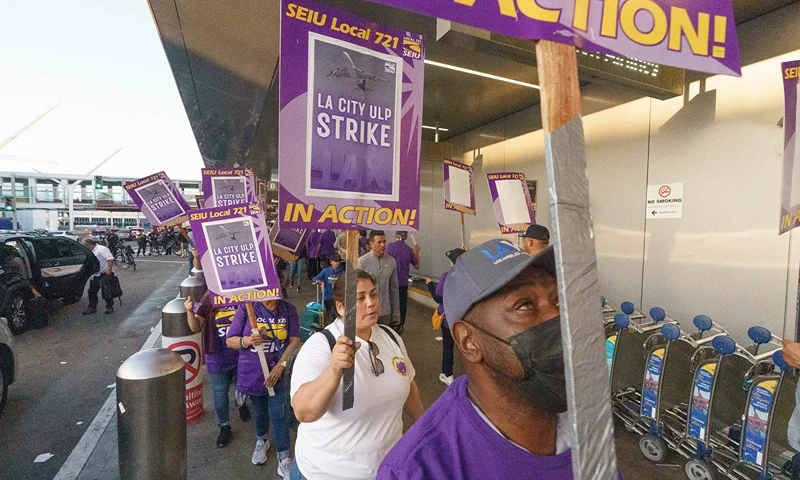 Workers with SEIU Local 721 - Southern California Public Service Workers join a picket line at the Los Angeles International Airport on Tuesday, Aug. 8, 2023. Thousands of Los Angeles city employees, including sanitation workers, engineers and traffic officers, walked off the job for a 24-hour strike alleging unfair labor practices. (AP Photo/Damian Dovarganes)