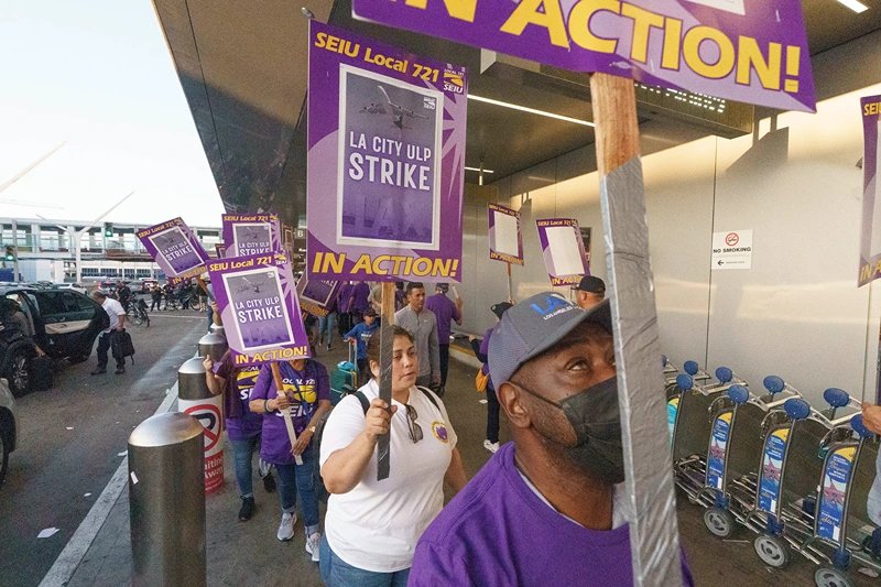 Workers with SEIU Local 721 - Southern California Public Service Workers join a picket line at the Los Angeles International Airport on Tuesday, Aug. 8, 2023. Thousands of Los Angeles city employees, including sanitation workers, engineers and traffic officers, walked off the job for a 24-hour strike alleging unfair labor practices. (AP Photo/Damian Dovarganes)