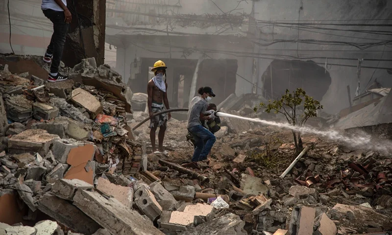 Dominican Republic Explosion Firefighters put out a fire after a powerful explosion in San Cristobal, Dominican Republic, Monday, Aug 14, 2023. The Monday afternoon explosion killed at least three people and injured more than 30 others, authorities said. (Jolivel Brito/Diario Libre via AP)