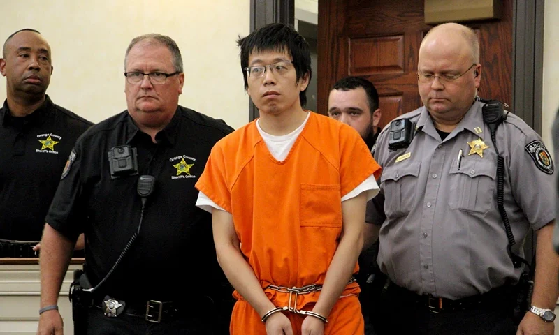University Fatal Shooting Tailei Qi, the graduate student suspected in the fatal shooting of a University of North Carolina at Chapel Hill faculty member, center, makes his first appearance at the Orange County Courthouse in Hillsborough, N.C., Tuesday, Aug. 29, 2023. Qi has been charged by the UNC Police Department with first-degree murder and possession of a weapon on educational property, both felony charges. (AP Photo/Hannah Schoenbaum)