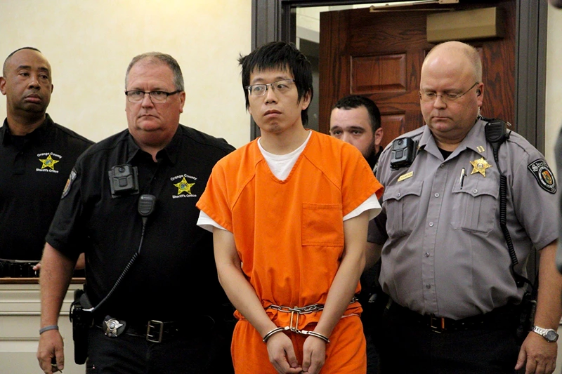 University Fatal Shooting
Tailei Qi, the graduate student suspected in the fatal shooting of a University of North Carolina at Chapel Hill faculty member, center, makes his first appearance at the Orange County Courthouse in Hillsborough, N.C., Tuesday, Aug. 29, 2023. Qi has been charged by the UNC Police Department with first-degree murder and possession of a weapon on educational property, both felony charges. (AP Photo/Hannah Schoenbaum)