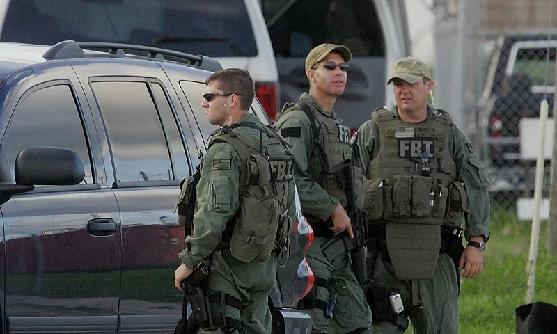 MIAMI - JUNE 22: FBI agents conduct what is being reported as a terrorism-related investigation near the Scott housing projects in the area of 15th Avenue and Northwest 62nd Street June 22, 2006 in the Liberty City neighborhood of Miami, Florida. The FBI had conducted several raids and made several arrests, according to federal officials. (Photo by Joe Raedle/Getty Images)