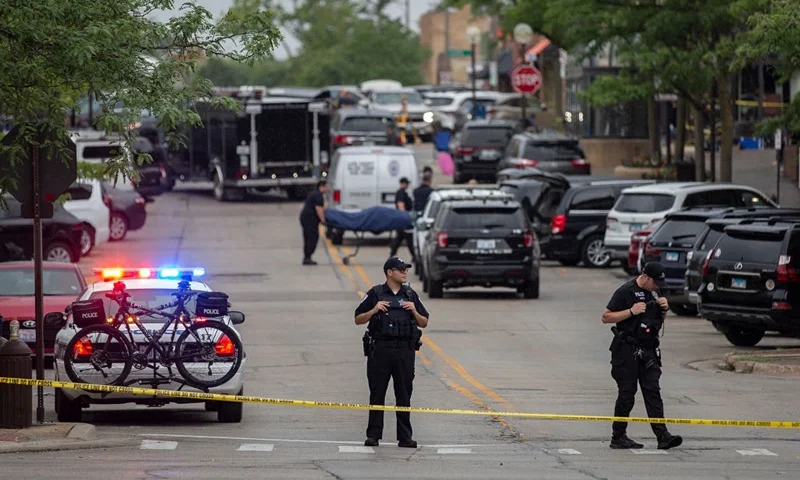 HIGHLAND PARK, IL - JULY 04: First responders take away victims from the scene of a mass shooting at a Fourth of July parade on July 4, 2022 in Highland Park, Illinois. At least six people were killed and 19 injured, according to published reports. (Photo by Jim Vondruska/Getty Images)
