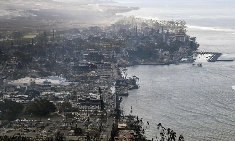 TOPSHOT - An aerial image taken on August 10, 2023 shows destroyed homes, buildings, and the harbor area burned to the ground in Lahaina in the aftermath of wildfires in western Maui, Hawaii. At least 36 people have died after a fast-moving wildfire turned Lahaina to ashes, officials said August 9, as visitors asked to leave the island of Maui found themselves stranded at the airport. The fires began burning early August 8, scorching thousands of acres and putting homes, businesses and 35,000 lives at risk on Maui, the Hawaii Emergency Management Agency said in a statement. (Photo by Patrick T. Fallon / AFP) (Photo by PATRICK T. FALLON/AFP via Getty Images)