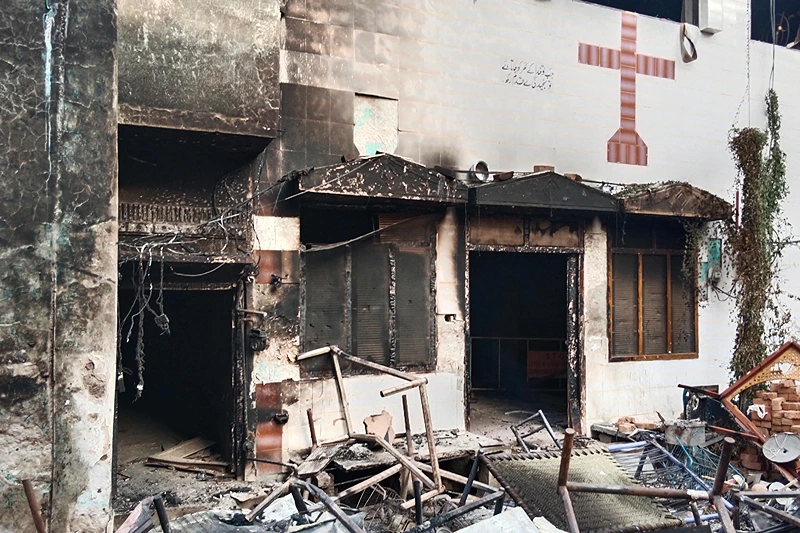 TOPSHOT - View of a burnt church on the outskirts of Faisalabad on August 16, 2023, following an attack by Muslim men after a Christian family was accused of blasphemy. Hundreds of Muslim men set fire to four churches and vandalised a cemetery during a rampage in eastern Pakistan on August 16, officials said, after a Christian family was accused of blasphemy. (Photo by Ghazanfar MAJID / AFP) (Photo by GHAZANFAR MAJID/AFP via Getty Images)
