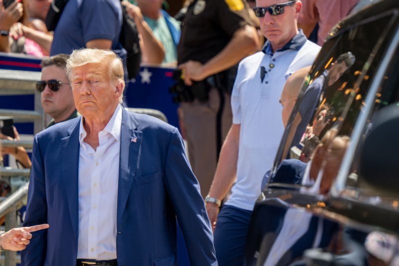 DES MOINES, IOWA - AUGUST 12: Republican presidential candidate and former U.S. President Donald Trump is directed to his vehicle after speaking at the Steer N' Stein bar at the Iowa State Fair on August 12, 2023 in Des Moines, Iowa. Republican and Democratic presidential hopefuls, including Florida Gov. Ron DeSantis, former President Donald Trump are visiting the fair, a tradition in one of the first states to hold caucuses in 2024. (Photo by Brandon Bell/Getty Images)