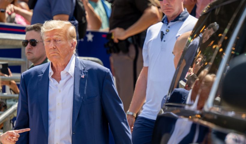 DES MOINES, IOWA - AUGUST 12: Republican presidential candidate and former U.S. President Donald Trump is directed to his vehicle after speaking at the Steer N' Stein bar at the Iowa State Fair on August 12, 2023 in Des Moines, Iowa. Republican and Democratic presidential hopefuls, including Florida Gov. Ron DeSantis, former President Donald Trump are visiting the fair, a tradition in one of the first states to hold caucuses in 2024. (Photo by Brandon Bell/Getty Images)