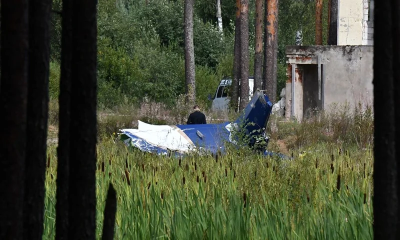 A law enforcement officer works at the site of a plane crash near the village of Kuzhenkino, Tver region, on August 24, 2023. Russian state-run news agencies on August 23, 2023 said that Yevgeny Prigozhin, the head of the Wagner group that led a mutiny against Russia's army in June, was on the list of passengers of a plane that crashed near the village of Kuzhenkino in the Tver region. (Photo by Olga MALTSEVA / AFP) (Photo by OLGA MALTSEVA/AFP via Getty Images)