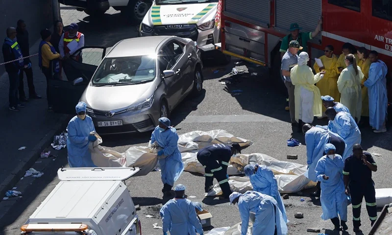 SAFRICA-FIRE EDITORS NOTE: Graphic content / Members of the forensic department moves bodies at the scene of a fire in Johannesburg on August 31, 2023. More than 70 people have died in a fire that engulfed a five-storey building in central Johannesburg on August 31, 2023, the South African city's emergency services said. (Photo by Guillem SARTORIO / AFP) (Photo by GUILLEM SARTORIO/AFP via Getty Images)