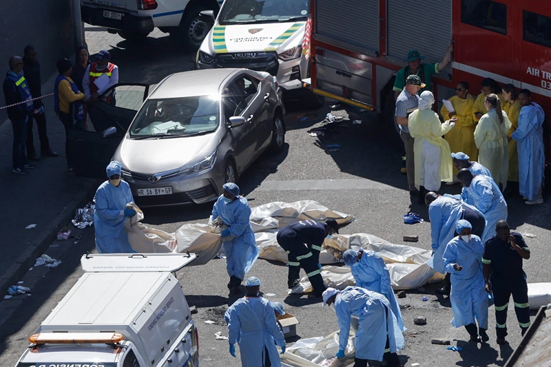 SAFRICA-FIRE
EDITORS NOTE: Graphic content / Members of the forensic department moves bodies at the scene of a fire in Johannesburg on August 31, 2023. More than 70 people have died in a fire that engulfed a five-storey building in central Johannesburg on August 31, 2023, the South African city's emergency services said. (Photo by Guillem SARTORIO / AFP) (Photo by GUILLEM SARTORIO/AFP via Getty Images)