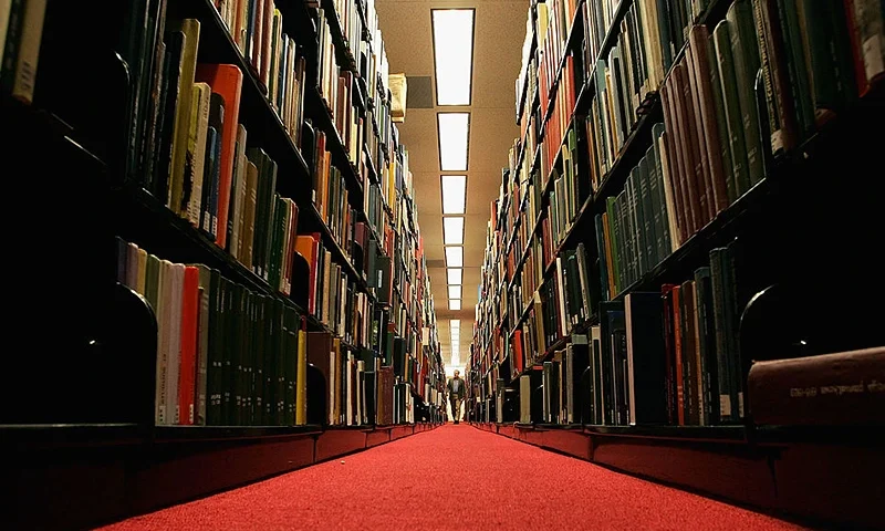 STANFORD, CA - DECEMBER 17: A man browses through books at the Cecil H. Green on the Stanford University Campus December 17, 2004 in Stanford, California. Google, the internet search engine, has announced a long-term project to put 15 million books from seven of the world's most prestigious libraries online and make them searchable. Included will be the libraries of Harvard, Stanford, the University of Michigan, the New York Public Library and the University of Oxford, including the Bodleian. Books and periodicals will be scanned and project is expected to take six years and cost more than $100 million. (Photo by Justin Sullivan/Getty Images)
