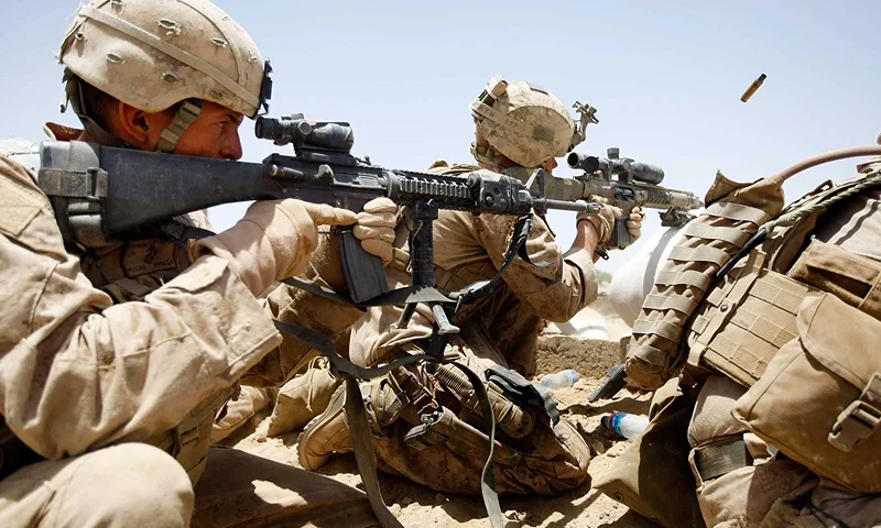 U.S. Marines Continue Suppression Of Insurgents MAIN POSHTEH, AFGHANISTAN - JULY 3: U.S. Marines from 2nd Marine Expeditionary Brigade, RCT 2nd Battalion 8th Marines Echo Co. shoot at enemy targets during a firefight on July 3, 2009 in Main Poshteh, Afghanistan. The Marines are part of Operation Khanjari which was launched to take areas in the Southern Helmand Province that Taliban fighters are using as a supply route and to help the local Afghan population prepare for the upcoming presidential elections. (Photo by Joe Raedle/Getty Images)