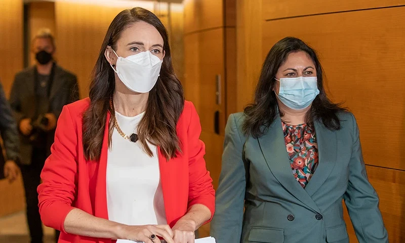 WELLINGTON, NEW ZEALAND - MARCH 23: Prime Minister Jacinda Ardern and Associate Health Minister Ayesha Verrall arrive ahead of their press conference to announce changes to COVID-19 Omicron vaccine and mandates rules at Parliament on March 23, 2022 in Wellington, New Zealand. Prime Minister Jacinda Ardern today announced some changes to New Zealand's COVID-19 response and restrictions following a National cabinet meeting. New Zealand's traffic light system of restrictions will remain in place to help manage any future COVID-19 outbreaks, but rules have been eased somewhat with number limits on all outdoor gatherings now removed. Indoor gathering limits will increase from 100 to 200 under the red light setting. (Photo by Mark Mitchell - Pool/Getty Images)