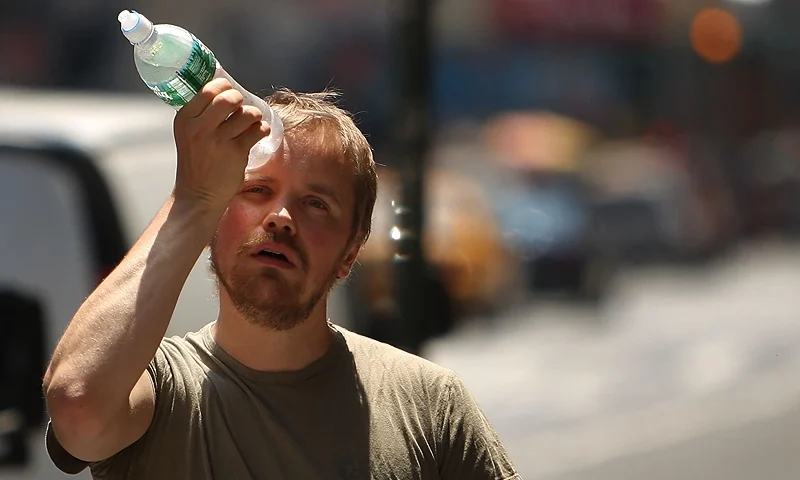 NEW YORK - JUNE 9: A man tries to cool himself with a bottle of water during the first heat wave of the year June 9, 2008 in New York City. According to the National Weather Service temperatures will near 100 degrees today in the New York metro area with no relief in sight until Wednesday, June 11. (Photo by Spencer Platt/Getty Images)