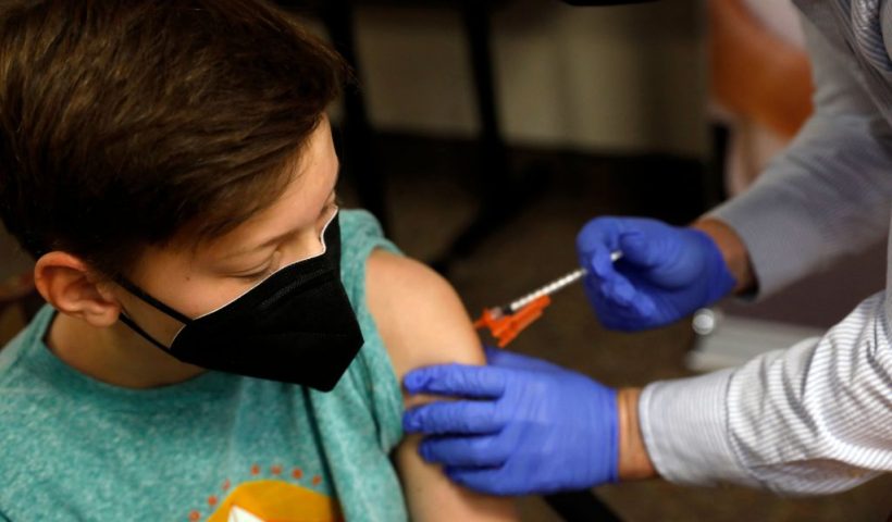 Aiden Arthurs receives the Pfizer-BioNTech Covid-19 Vaccine from Pharmacist Andrew Mac (R) at the Jewish Federation/JARC's offices in Bloomfield Hills, Michigan, on May 13, 2021. - The US Food and Drug Administration (FDA) on May 10, 2021 authorized the use of the Pfizer-BioNTech Covid-19 vaccine for children aged 12 to 15 years old. (Photo by JEFF KOWALSKY / AFP) (Photo by JEFF KOWALSKY/AFP via Getty Images)
