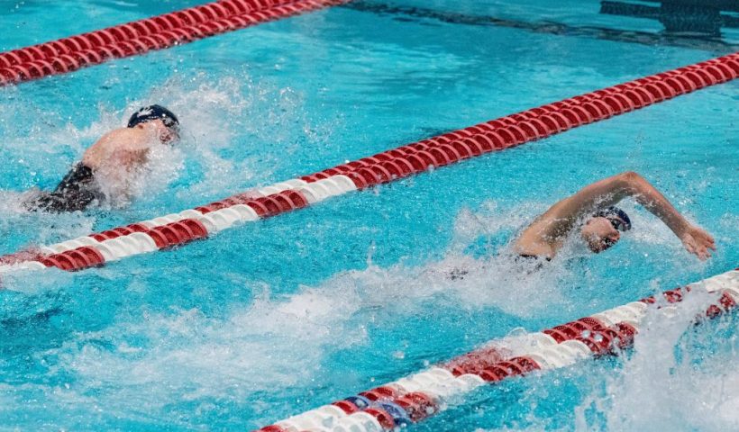 Transgender swimmer Lia Thomas (R) of Penn University and transgender swimmer Iszac Henig (L) of Yale compete in the 100-yard freestyle swimming race at the 2022 Ivy League Women's Swimming & Diving Championships at Harvard University in Cambridge, Massachusetts on February 19, 2022. - Thomas took first place with a time of 47.63 and Henig took second place with a time of 47.82. (Photo by Joseph Prezioso / AFP) (Photo by JOSEPH PREZIOSO/AFP via Getty Images)