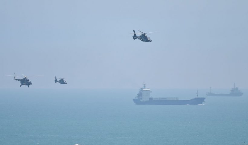 TOPSHOT - Chinese military helicopters fly past Pingtan island, one of mainland China's closest point from Taiwan, in Fujian province on August 4, 2022, ahead of massive military drills off Taiwan following US House Speaker Nancy Pelosi's visit to the self-ruled island. - China is due on August 4 to kick off its largest-ever military exercises encircling Taiwan, in a show of force straddling vital international shipping lanes following a visit to the self-ruled island by US House Speaker Nancy Pelosi. (Photo by Hector RETAMAL / AFP) (Photo by HECTOR RETAMAL/AFP via Getty Images)
