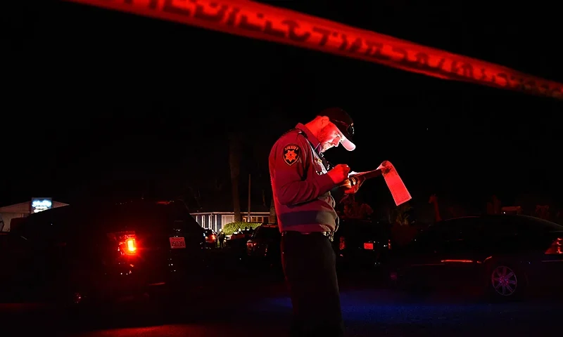 TOPSHOT - A San Mateo County sheriff deputy stands at the scene of a shooting on highway 92 in Half Moon Bay, California on January 23, 2023. - An Asian farm worker was in custody January 23, 2023 after seven of his colleagues were killed in front of children at sites in California, days after a mass shooter killed 11 people at a Lunar New Year celebration near Los Angeles. The latest bloodshed to hit Asian Americans in California occurred at two farms around Half Moon Bay, a coastal community near San Francisco. (Photo by Susana BATES / AFP) (Photo by SUSANA BATES/AFP via Getty Images)
