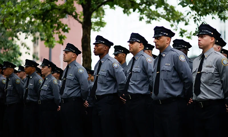 Law enforcement officers stand at the 9/11 memorial pool prior to a remembrance ceremony on the 22nd anniversary of the terror attack on the World Trade Center, in New York City on September 11, 2023. (Photo by KENA BETANCUR / AFP) (Photo by KENA BETANCUR/AFP via Getty Images)