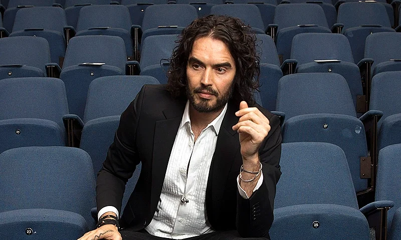 LONDON, ENGLAND - NOVEMBER 25: Russell Brand poses for photographs as he arrives to deliver The Reading Agency Lecture at The Institute of Education on November 25, 2014 in London, England. Russell Brand will deliver 'a manifesto on reading' which will be in part personal, sharing his own experience of books and reading while growing up in the UK. (Photo by Carl Court/Getty Images)