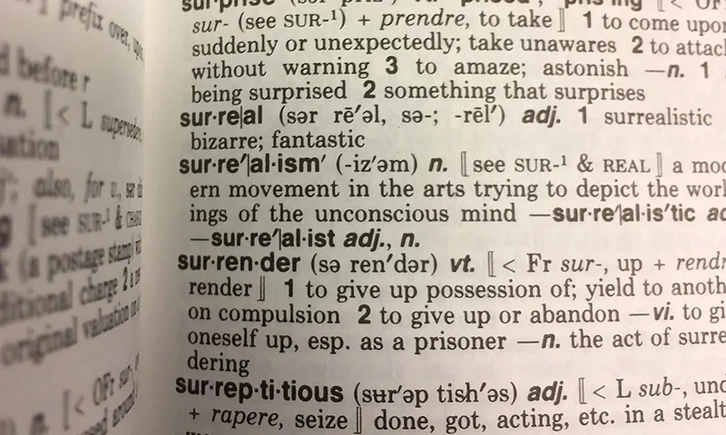 This December 16, 2016 photo illustration taken in Washington, DC. shows the definition for the word "Surreal" in a copy of the Webster's Desktop Dictionary. Donald Trump's upset win in the US presidential election astonished people so much that they rushed to the dictionary to look up the word everyone was using to describe the event: surreal. Indeed, Merriam-Webster's dictionary on Monday named surreal its Word of the Year 2016, the honor given to the word or term with the sharpest spike in look-ups over the previous year. / AFP / Karen BLEIER (Photo credit should read KAREN BLEIER/AFP via Getty Images)