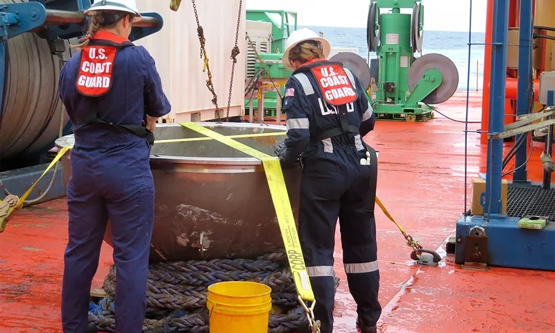Titan Tourist Sub In this photo provided by the U.S. National Transportation Safety Board, U.S. Coast Guard marine safety engineers assigned to the Marine Safety Center in Washington D.C., working for the Marine Board of Investigation for the Titan submersible case, conduct a survey of the aft titanium endcap from the Titan submersible, in the North Atlantic Ocean, Sunday, Oct. 1, 2023. The endcap was recently recovered from the seafloor and successfully transferred to a U.S. port for analysis. (U.S. National Transportation Safety Board via AP)