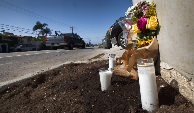 Candles and flowers are placed along along the Pacific Coast Highway, after a crash that killed four college students and injured two others, in Malibu, Calif., on Thursday, Oct. 19, 2023. Officials say police have arrested a 22-year-old driver on suspicion of manslaughter. Sheriff's officials say six pedestrians were struck at about 8:30 p.m. Tuesday along Pacific Coast Highway, a few miles east of Pepperdine University. (AP Photo/Richard Vogel)