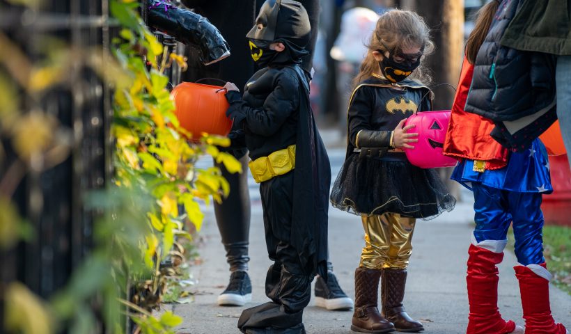 NEW YORK, NY - OCTOBER 31: Children receive treats by candy chutes while trick-or-treating for Halloween in Woodlawn Heights on October 31, 2020 in New York City. The CDC shared on their website alternative ways to still celebrate the holiday while being safe. (Photo by David Dee Delgado/Getty Images)