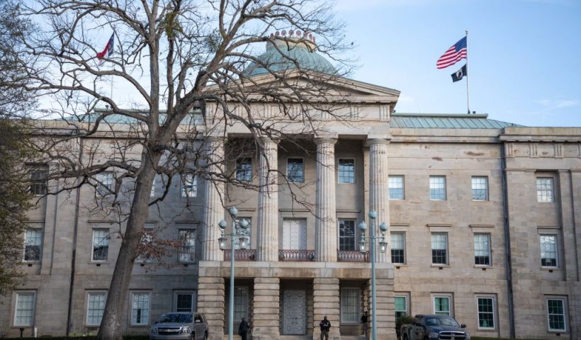 Law enforcement stand guard outside of the state capitol building in downtown Raleigh, North Carolina, on January 17, 2021, during a nationwide protest called by anti-government and far-right groups supporting US President Donald Trump and his claim of electoral fraud in the November 3 presidential election. - The FBI warned authorities in all 50 states to prepare for armed protests at state capitals in the days leading up to the January 20 presidential inauguration of President-elect Joe Biden. (Photo by Logan Cyrus / AFP) (Photo by LOGAN CYRUS/AFP via Getty Images)
