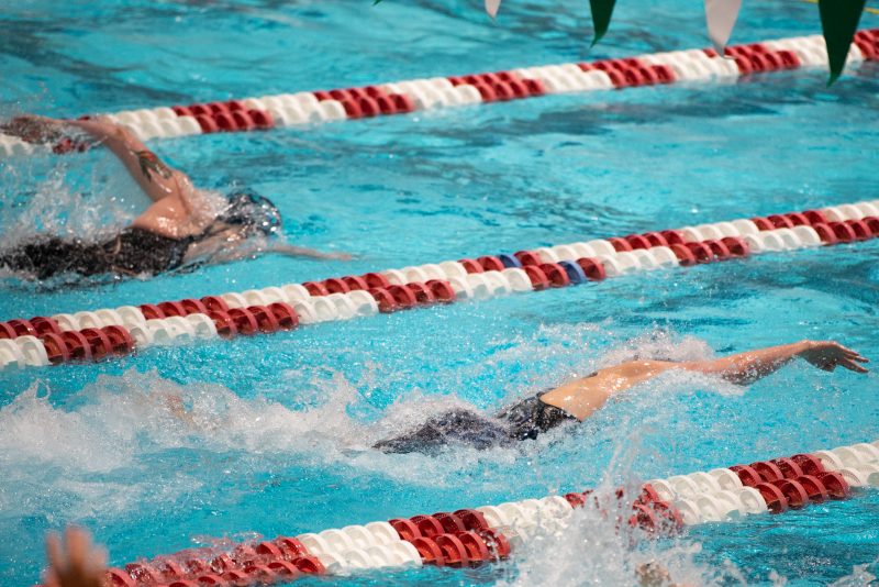 CAMBRIDGE, MA - FEBRUARY 19: University of Pennsylvania swimmer Lia Thomas (R) swims against Yale University swimmer Iszac Henig (L) during the 100 yard freestyle during the 2022 Ivy League Womens Swimming and Diving Championships at Blodgett Pool on February 19, 2022 in Cambridge, Massachusetts. (Photo by Kathryn Riley/Getty Images)